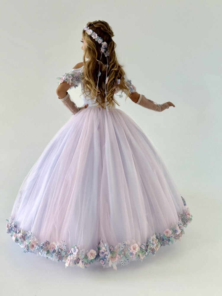 Back view of Florence gown for girls in lavender-pink with floral hem trim, sheer gloves, and cascading ribbons—styled for weddings, pageants, and fairy-tale celebrations.