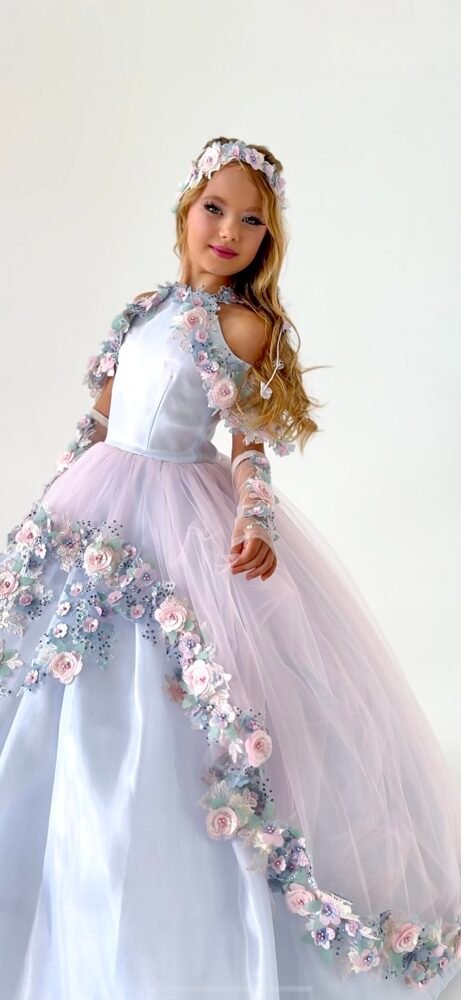 Florence gown for girls in white and lavender with cold shoulder sleeves, pastel floral trim, and voluminous tulle skirt—styled with matching headband and wrist accessories for weddings, pageants, and princess-themed events.