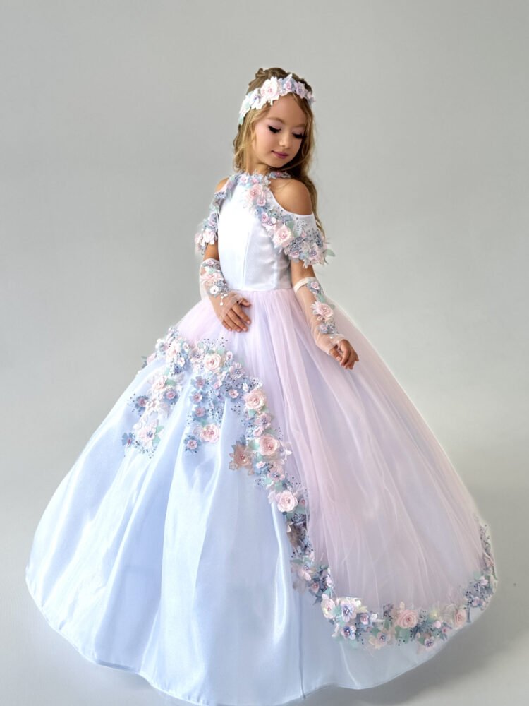 Florence gown for girls in white and blush pink with cold shoulder sleeves, pastel floral appliqués, and matching headband—ideal for weddings, pageants, and princess-themed celebrations.