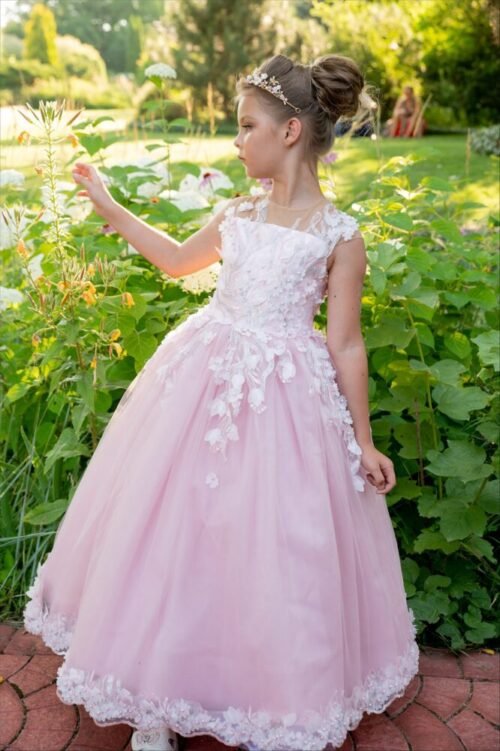 Ivy pink ball gown with sheer neckline, floral lace bodice, and layered tulle skirt—styled outdoors in a garden with blooming flowers and greenery for weddings, fantasy shoots, and royal-themed celebrations.